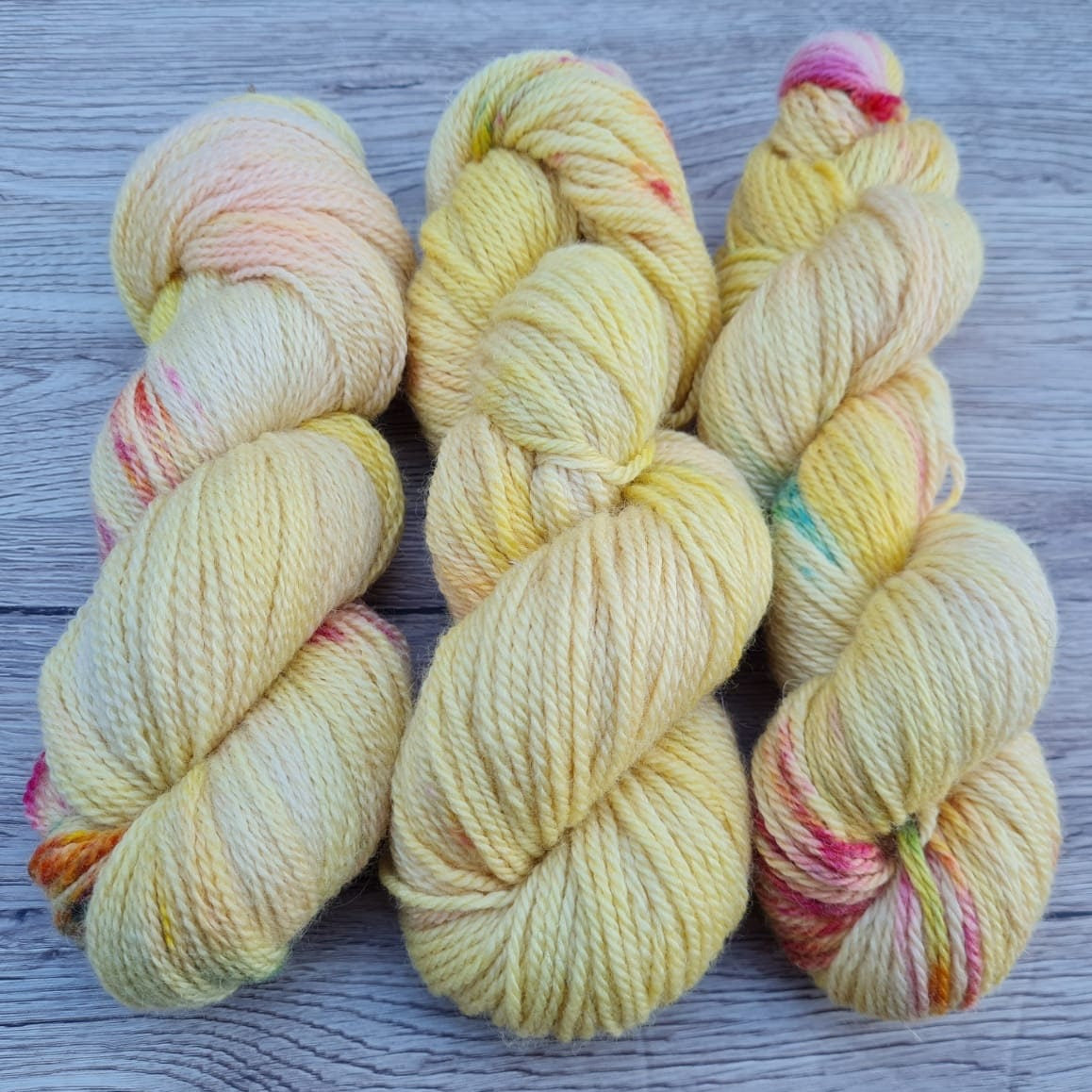 Three skeins of yellow yarn.